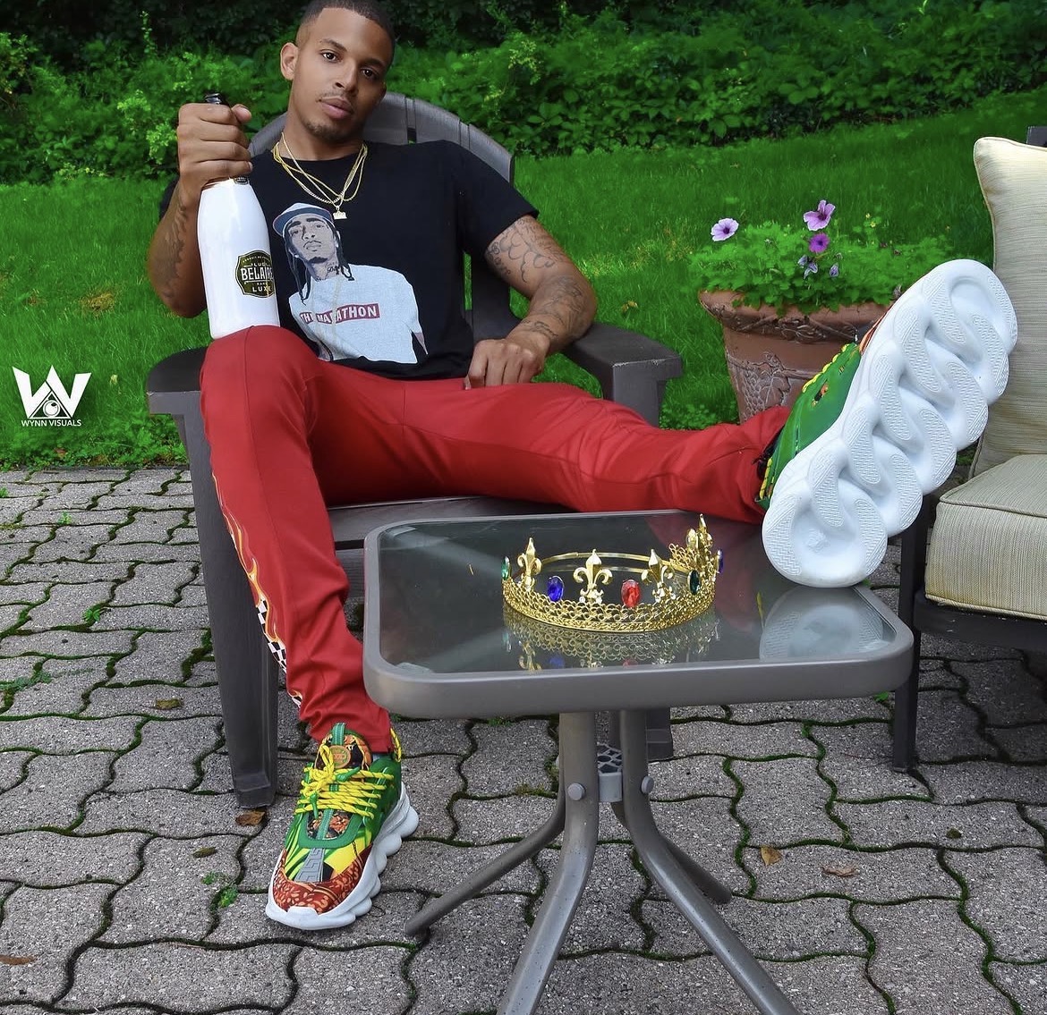 Style portrait seated outdoors in red and colour-blocked sneakers